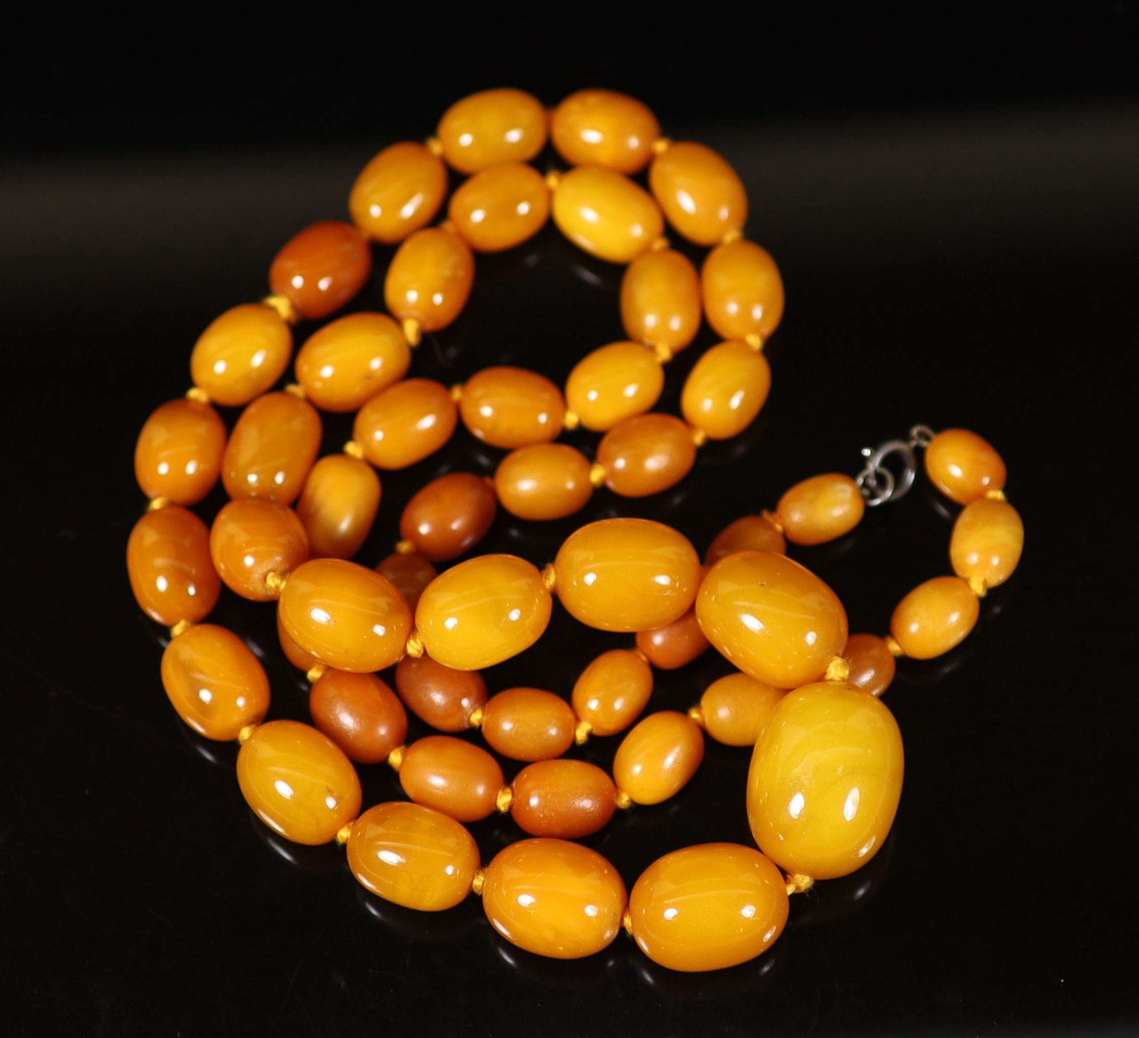 A single strand graduated oval amber bead necklace